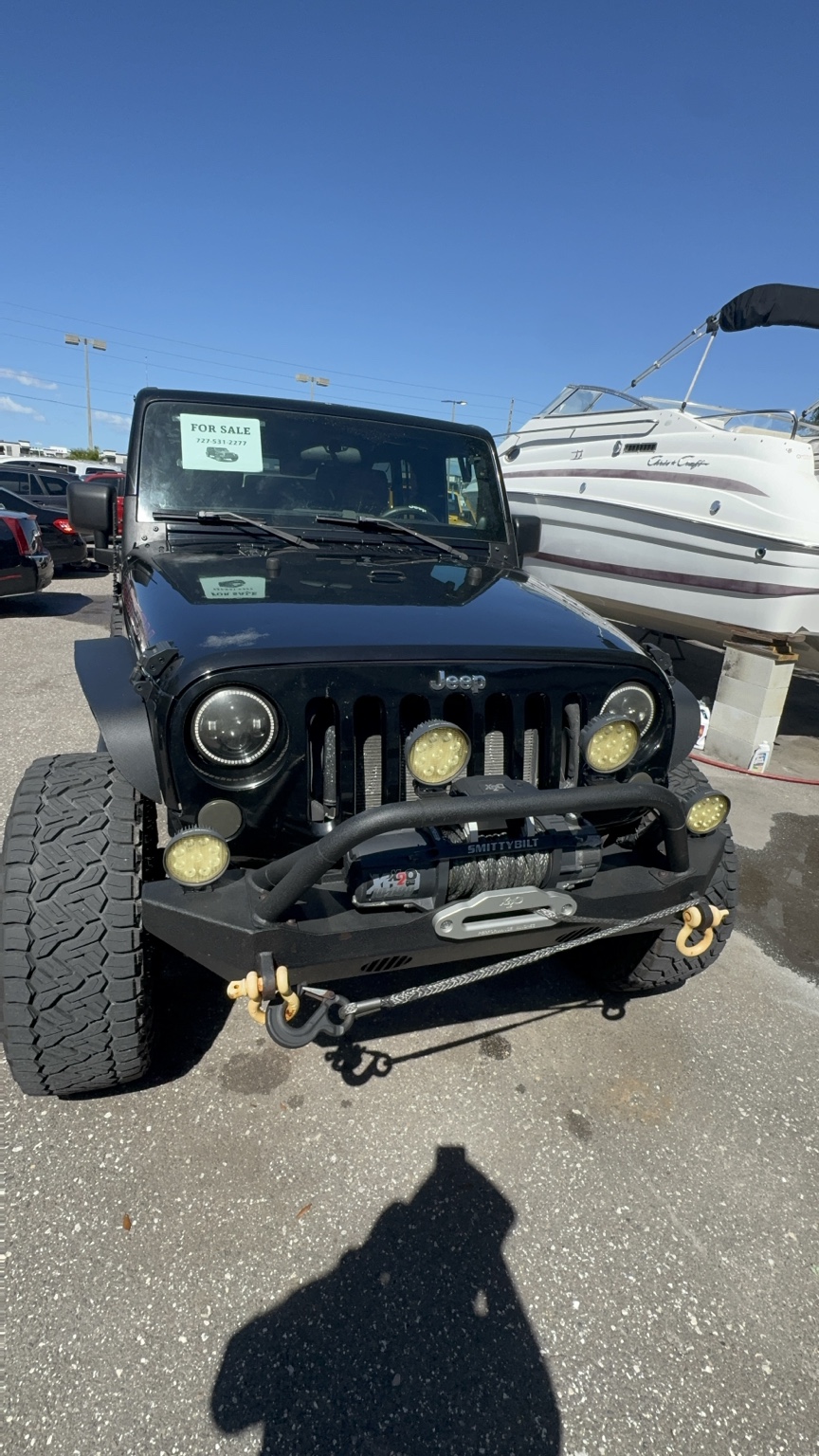 A black Jeep photographed on the Renown Automotive lot
